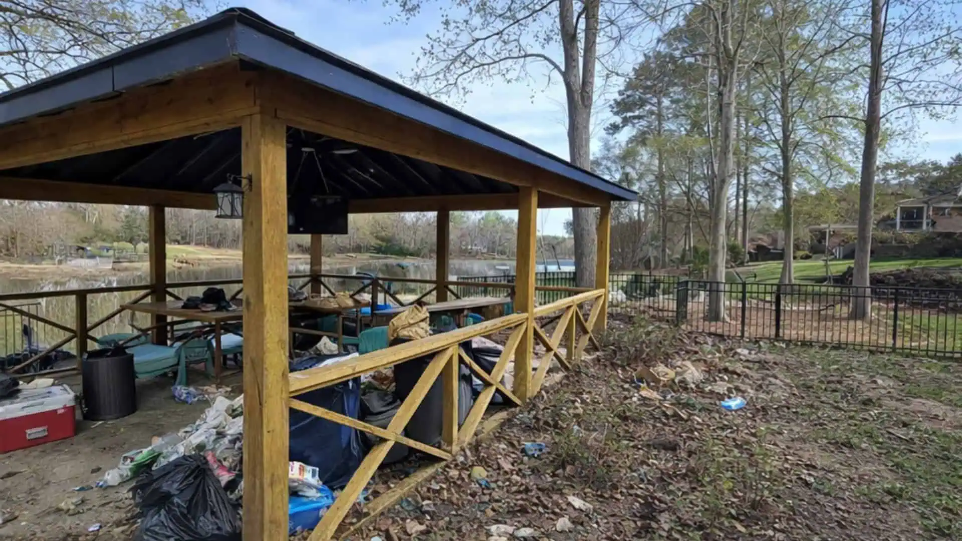 Well-maintained lawn and landscape with wooden gazebo and fencing.